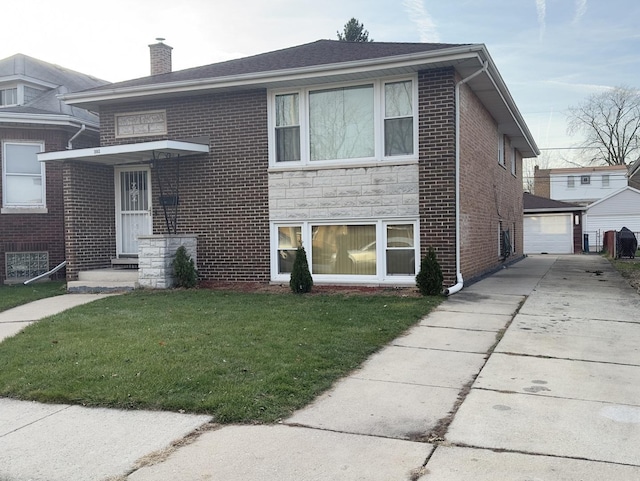 392 Luella Ave, Calumet City, IL 60409 - view of front of property with a chimney, driveway, a front yard, brick siding, and an outbuilding