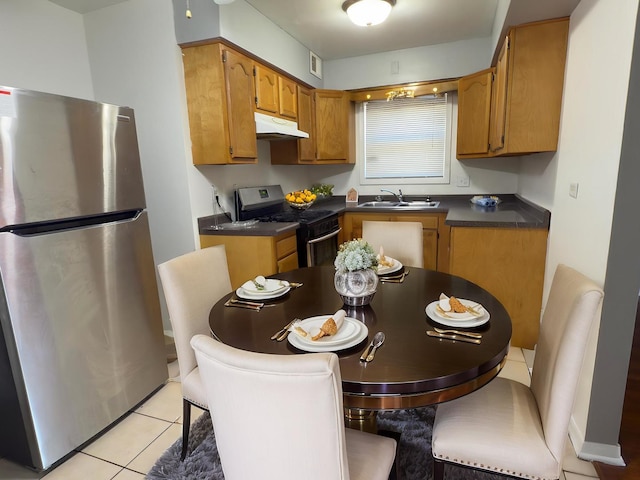 392 Luella Ave, Calumet City, IL 60409 - kitchen with appliances with stainless steel finishes, under cabinet range hood, dark countertops, a sink, and brown cabinets