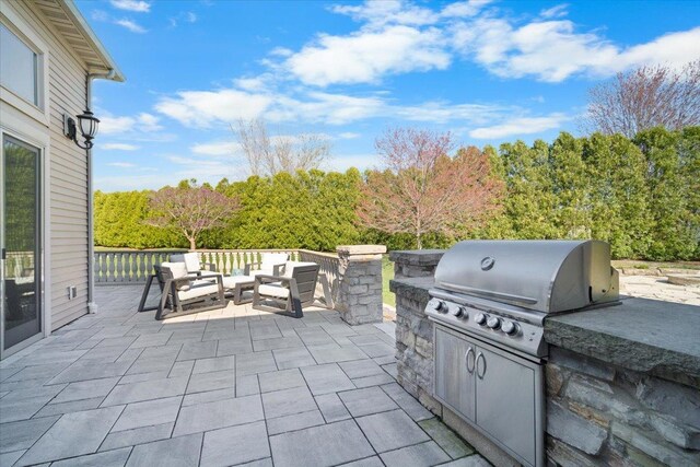 view of patio / terrace featuring exterior kitchen, an outdoor living space, and grilling area