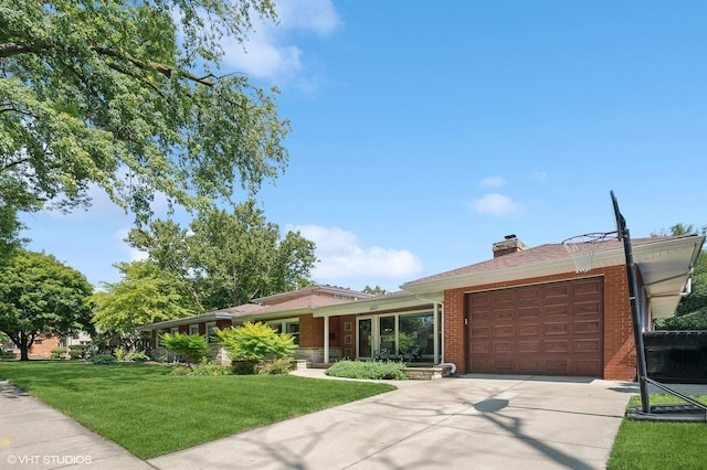 single story home with a front yard, a chimney, brick siding, an attached garage, and driveway