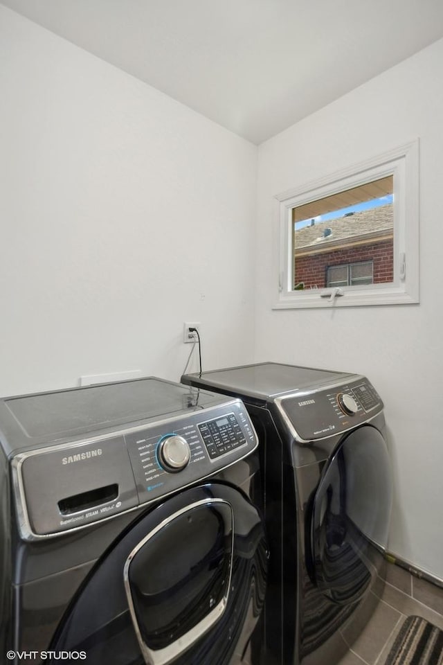 washroom with laundry area, tile patterned floors, and washer and dryer
