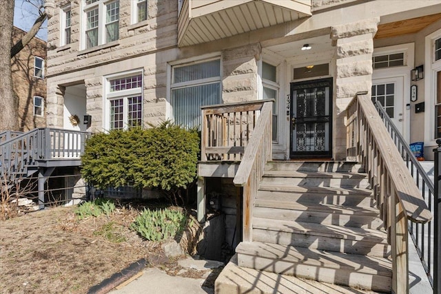doorway to property with stone siding