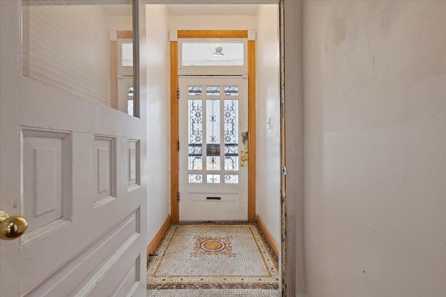 doorway featuring baseboards
