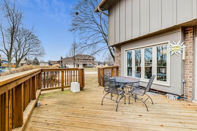 deck with a residential view and outdoor dining space