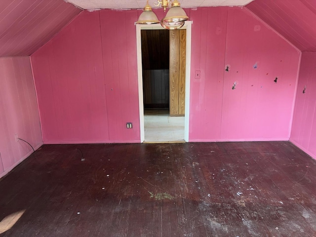 additional living space with vaulted ceiling and hardwood / wood-style floors