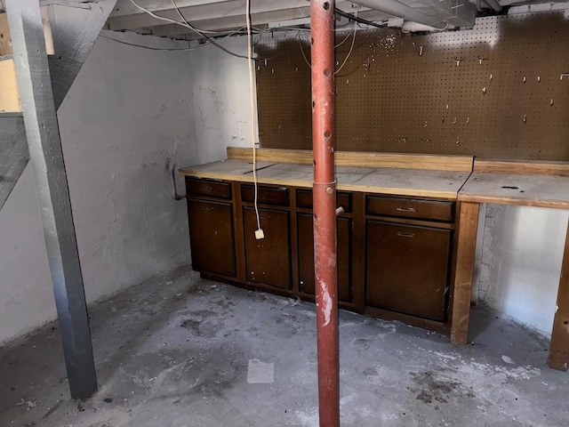 unfinished basement with a workshop area