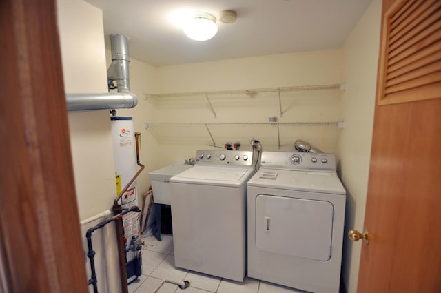 9514 S Kilbourn Ave Unit 3B, Oak Lawn, IL 60453 - clothes washing area featuring light tile patterned floors, a sink, laundry area, washing machine and clothes dryer, and gas water heater