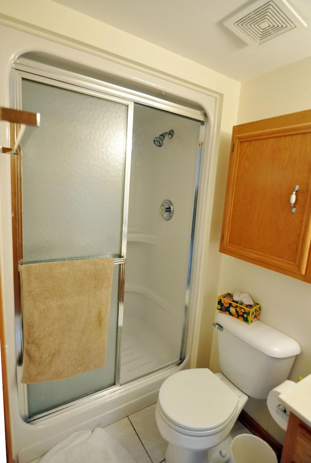 9514 S Kilbourn Ave Unit 3B, Oak Lawn, IL 60453 - bathroom with vanity, visible vents, toilet, a stall shower, and tile patterned floors