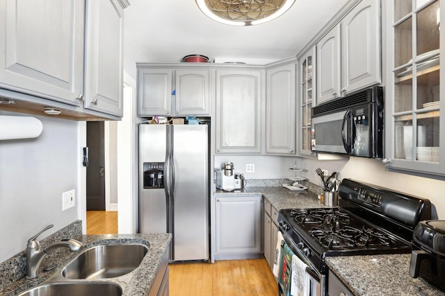 1606 W Winona St Unit 3, Chicago, IL 60640 - kitchen with gas range oven, stainless steel fridge, black microwave, glass insert cabinets, and a sink