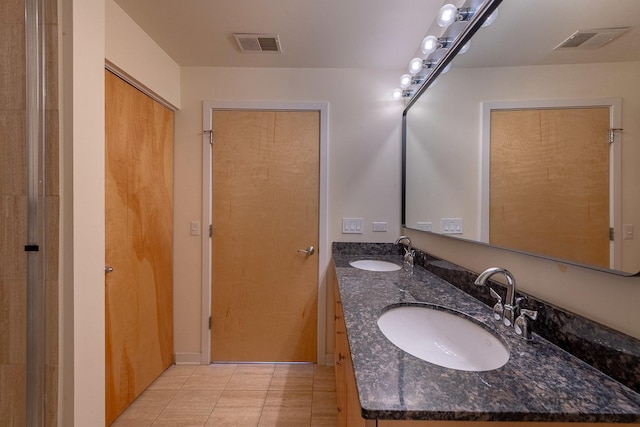 bathroom with tile patterned floors, visible vents, and a sink