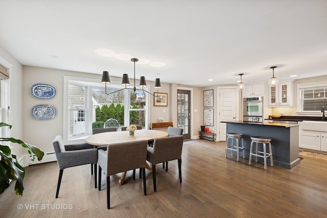 dining area with a baseboard radiator and wood finished floors