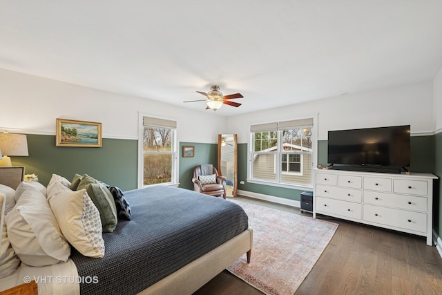 bedroom featuring ceiling fan, baseboards, and dark wood-style floors