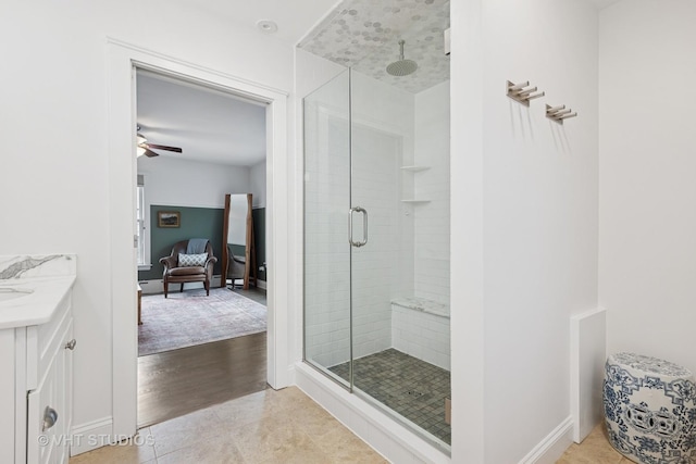 full bathroom featuring a stall shower, vanity, and tile patterned flooring