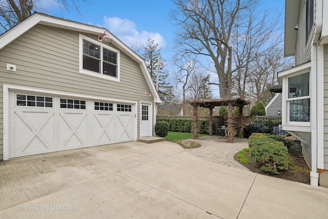 view of side of home featuring a gambrel roof, fence, and an outdoor structure