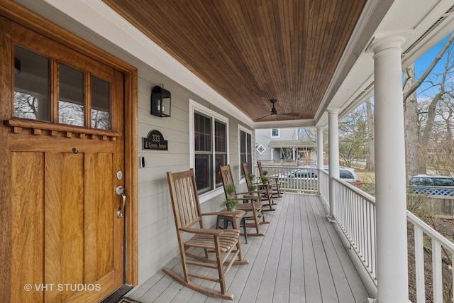 wooden deck with a porch and ceiling fan