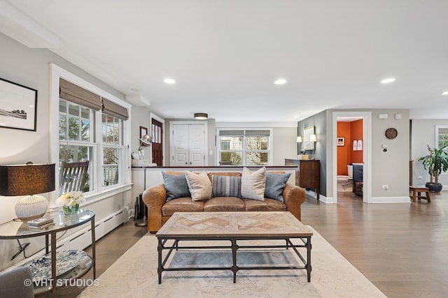 living area with baseboards, recessed lighting, and wood finished floors