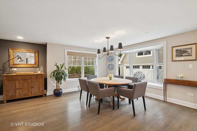 dining area with wood finished floors, an inviting chandelier, baseboards, and recessed lighting