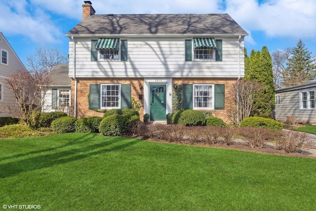 3916 Franklin Ave, Western Springs, IL 60558 - colonial home with roof with shingles, a chimney, a front lawn, and brick siding