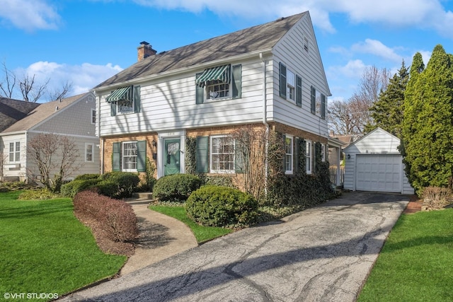 3916 Franklin Ave, Western Springs, IL 60558 - colonial home with an outbuilding, a garage, a front lawn, and a chimney