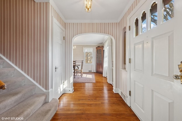 3916 Franklin Ave, Western Springs, IL 60558 - entryway with crown molding, arched walkways, wood finished floors, and wallpapered walls