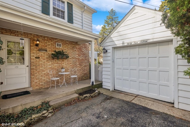 3916 Franklin Ave, Western Springs, IL 60558 - view of exterior entry with a porch, a garage, and brick siding