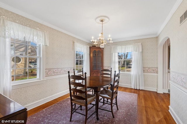 3916 Franklin Ave, Western Springs, IL 60558 - dining space with arched walkways, wainscoting, wallpapered walls, and wood finished floors