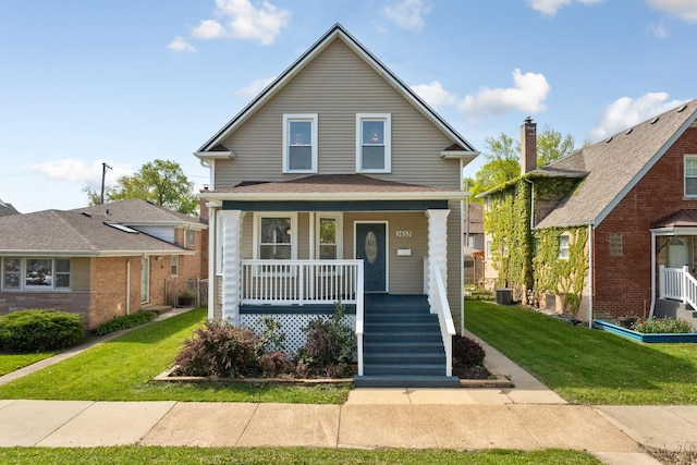 5653 W Byron St, Chicago, IL 60634 - view of front of house with covered porch, a front yard, and central AC