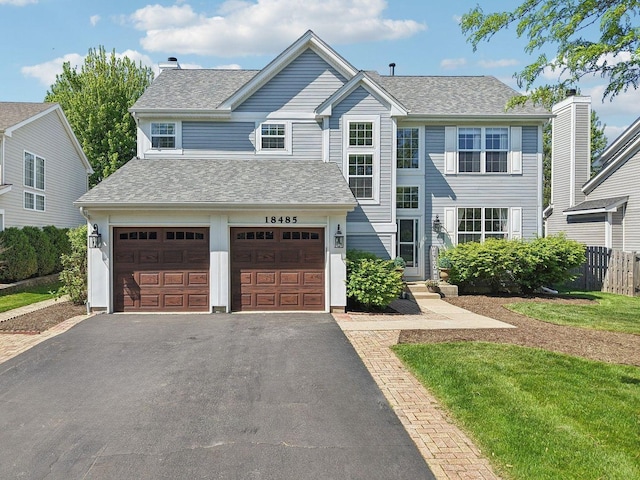18485 W Springwood Dr, Grayslake, IL 60030 - view of front facade featuring driveway, a garage, a shingled roof, and a chimney