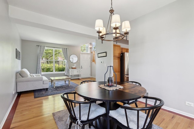 18485 W Springwood Dr, Grayslake, IL 60030 - dining area with a chandelier, light wood finished floors, and baseboards