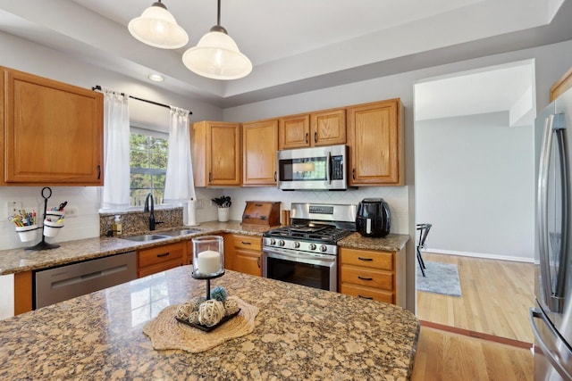 18485 W Springwood Dr, Grayslake, IL 60030 - kitchen with stainless steel appliances, a sink, stone countertops, tasteful backsplash, and light wood-type flooring