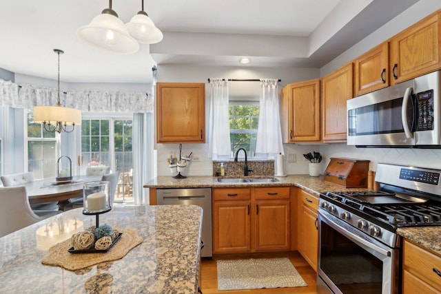 18485 W Springwood Dr, Grayslake, IL 60030 - kitchen with appliances with stainless steel finishes, a sink, healthy amount of natural light, and light stone countertops