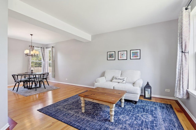 18485 W Springwood Dr, Grayslake, IL 60030 - living area featuring a chandelier, wood finished floors, and baseboards