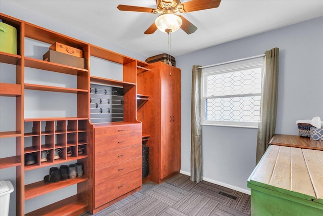 spacious closet with ceiling fan and visible vents