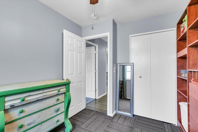 bedroom featuring a closet, baseboards, and ceiling fan