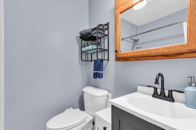 bathroom with vanity, walk in shower, and toilet