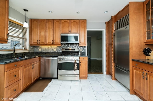 1131 S Hamlin Ave, Park Ridge, IL 60068 - kitchen featuring appliances with stainless steel finishes, brown cabinets, tasteful backsplash, and glass insert cabinets