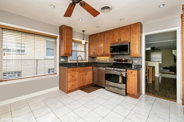 1131 S Hamlin Ave, Park Ridge, IL 60068 - kitchen featuring stainless steel appliances, a ceiling fan, tasteful backsplash, brown cabinetry, and pendant lighting