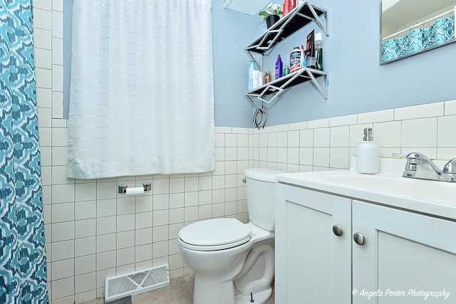 43 Lippincott Rd, Fox Lake, IL 60020 - full bathroom featuring toilet, tile walls, wainscoting, visible vents, and vanity