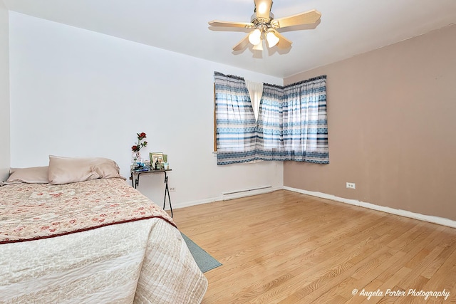 43 Lippincott Rd, Fox Lake, IL 60020 - bedroom featuring a baseboard heating unit, baseboards, a ceiling fan, and wood finished floors