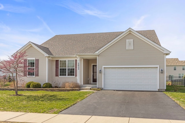 view of front of property featuring a front yard, fence, driveway, and roof with shingles