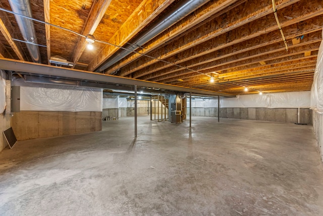 unfinished basement featuring heating unit