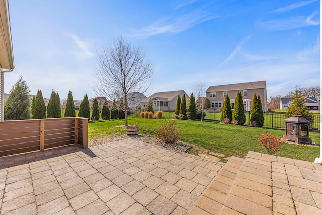 view of patio featuring a gazebo, a residential view, and fence