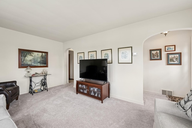 130 3rd St, Bloomingdale, IL 60108 - carpeted living room with arched walkways, baseboards, and visible vents