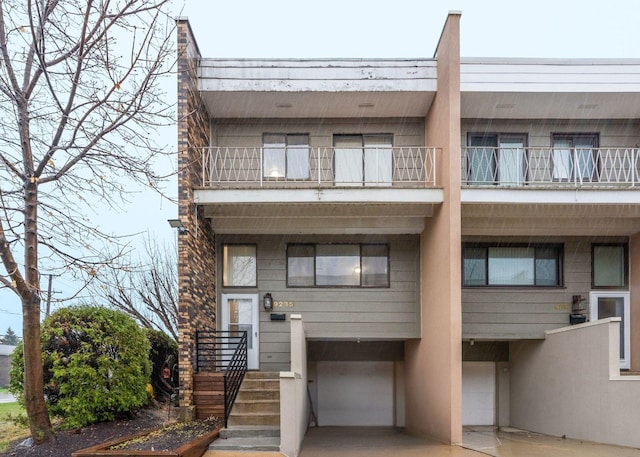 9235 W Ballard Rd Unit 101, Des Plaines, IL 60016 - view of front of property featuring a garage and a balcony