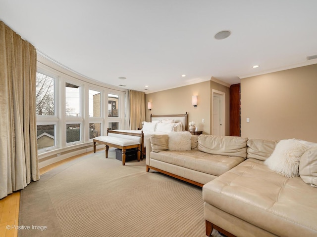 living area with ornamental molding and recessed lighting