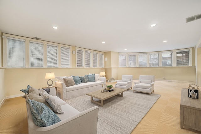 living room with baseboards, visible vents, and recessed lighting
