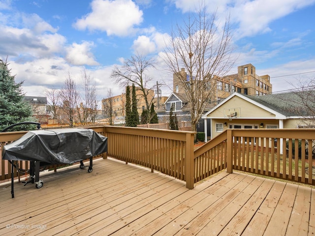 wooden terrace featuring a grill