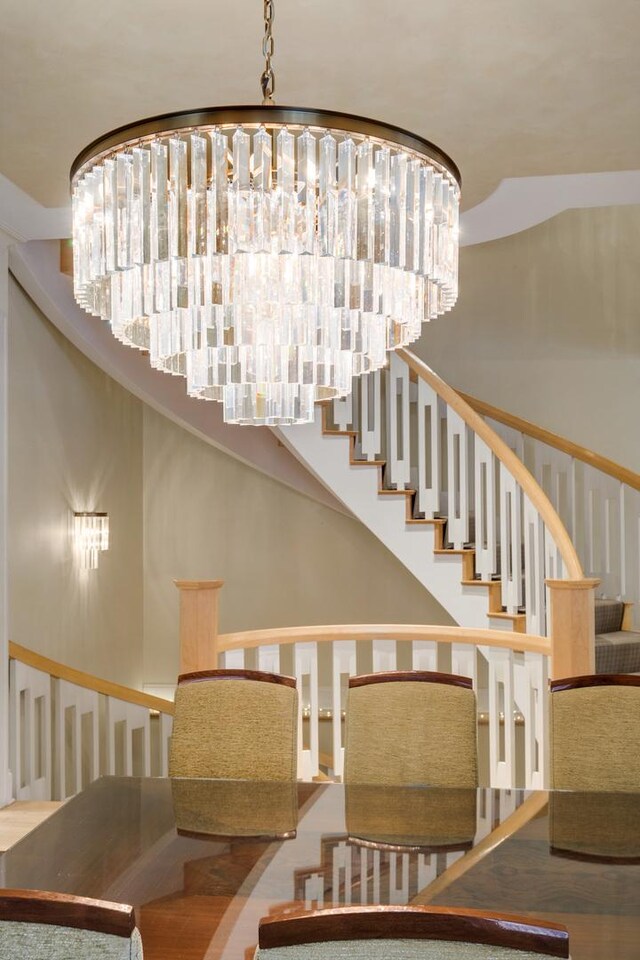 staircase with a chandelier
