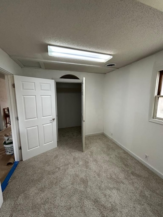 117 N Vermilion St, Potomac, IL 61865 - unfurnished bedroom featuring a textured ceiling, carpet, and attic access