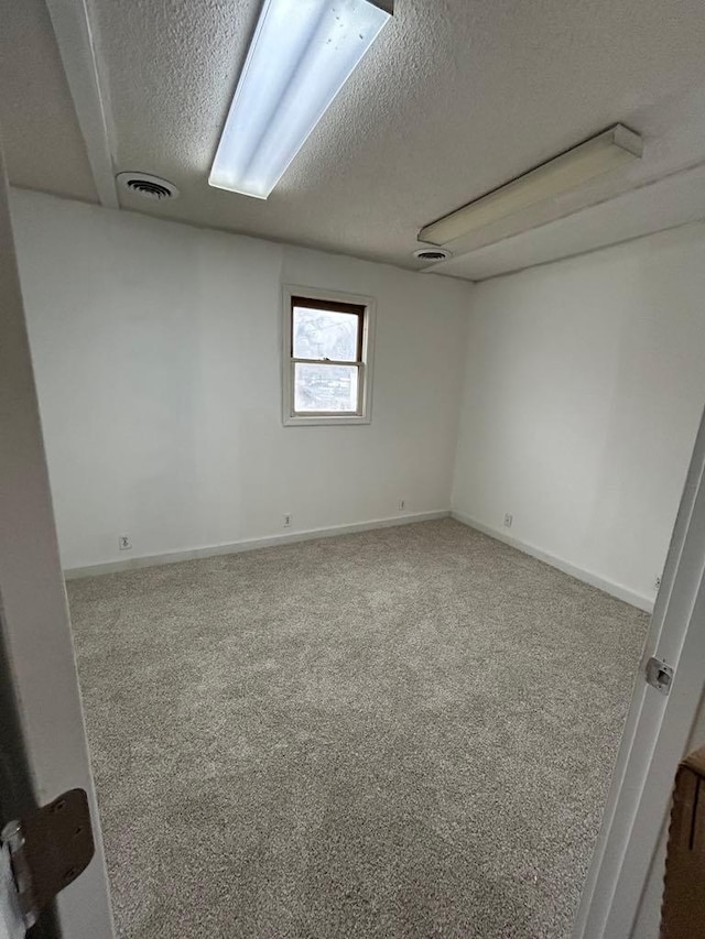 117 N Vermilion St, Potomac, IL 61865 - spare room featuring a textured ceiling, carpet flooring, and baseboards